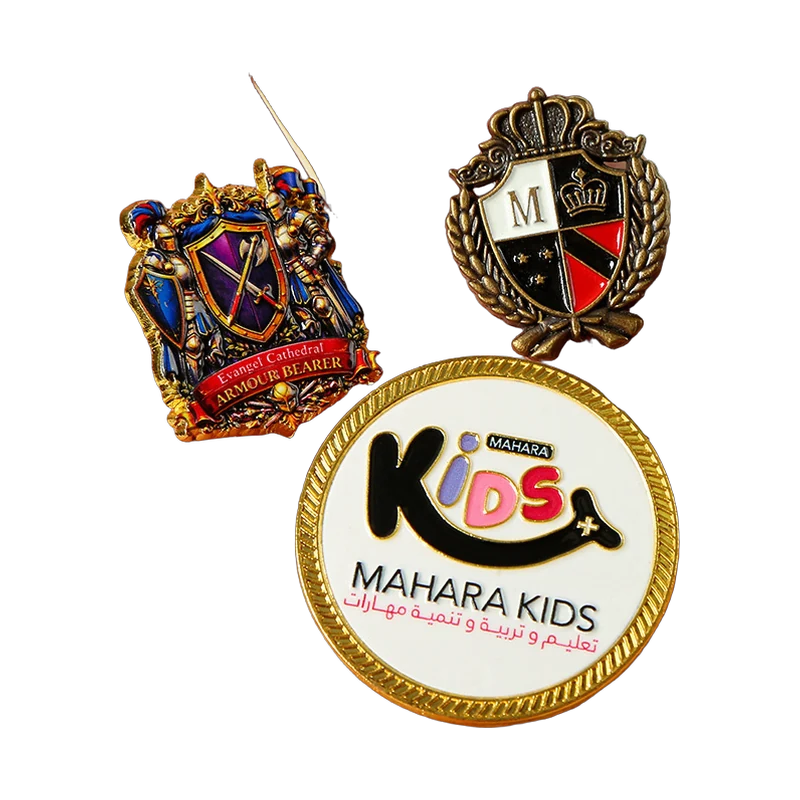 Assortment of custom enamel pins displayed on a hand