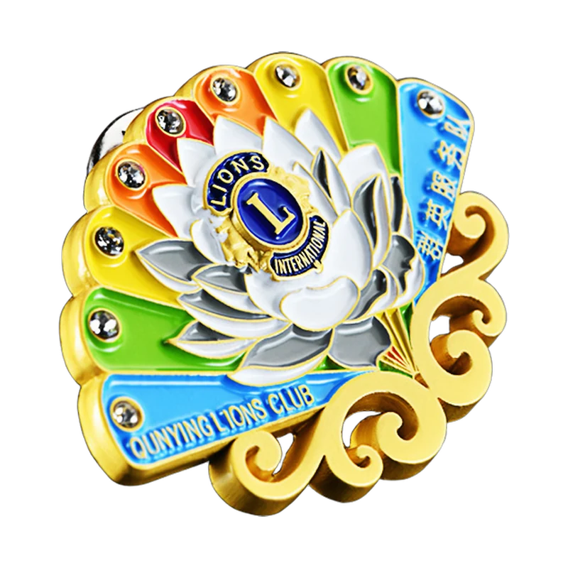 Multicolor enamel emblem pin with gold-colored borders and decorative stones