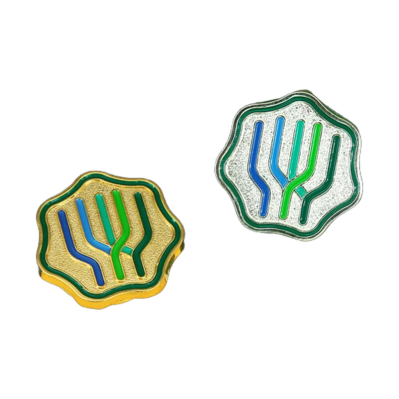 Two soft enamel pins with textured metal and blue and green linework